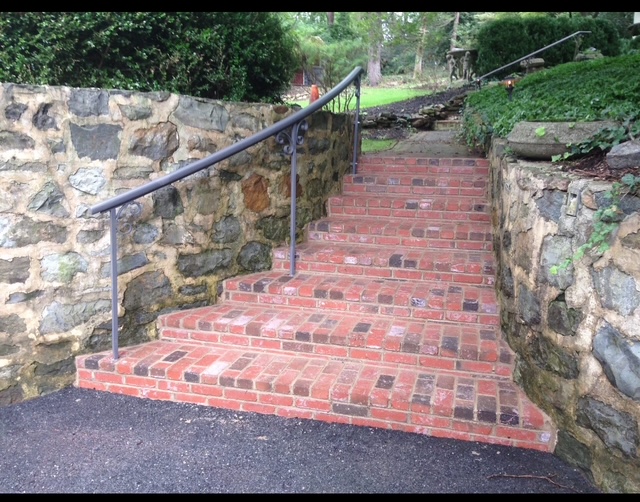 Brick garden steps between hand-laid stone retaining walls