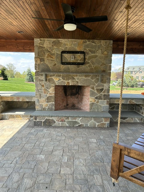 Stone fireplace with brick firebox and bluestone hearth
