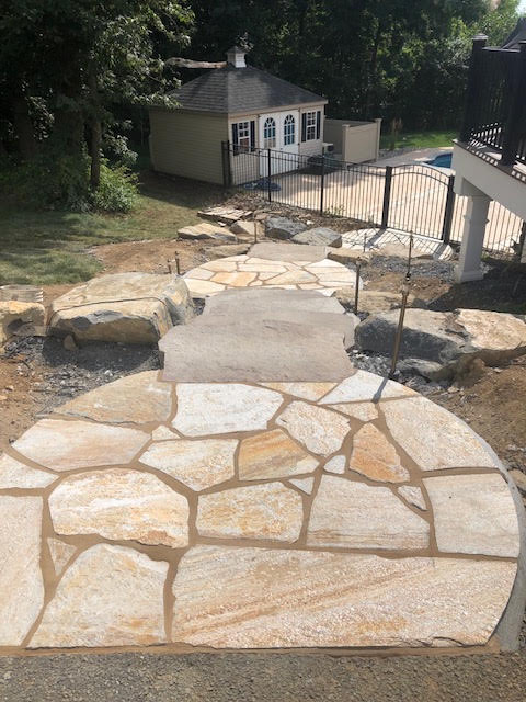 Irregular flagstone walkway leading to pool and pool house